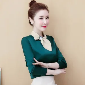 Green long-sleeved satin blouse with beige bow