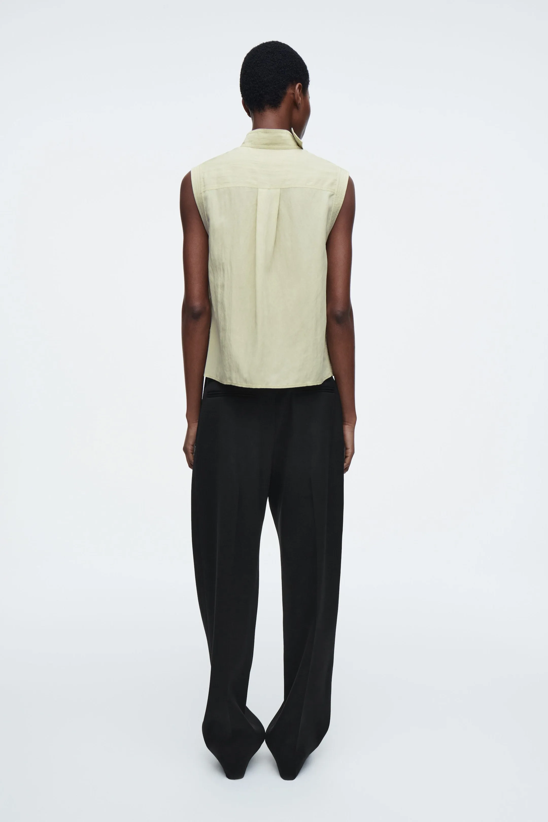 Sleeveless cut-out cowl-neck blouse