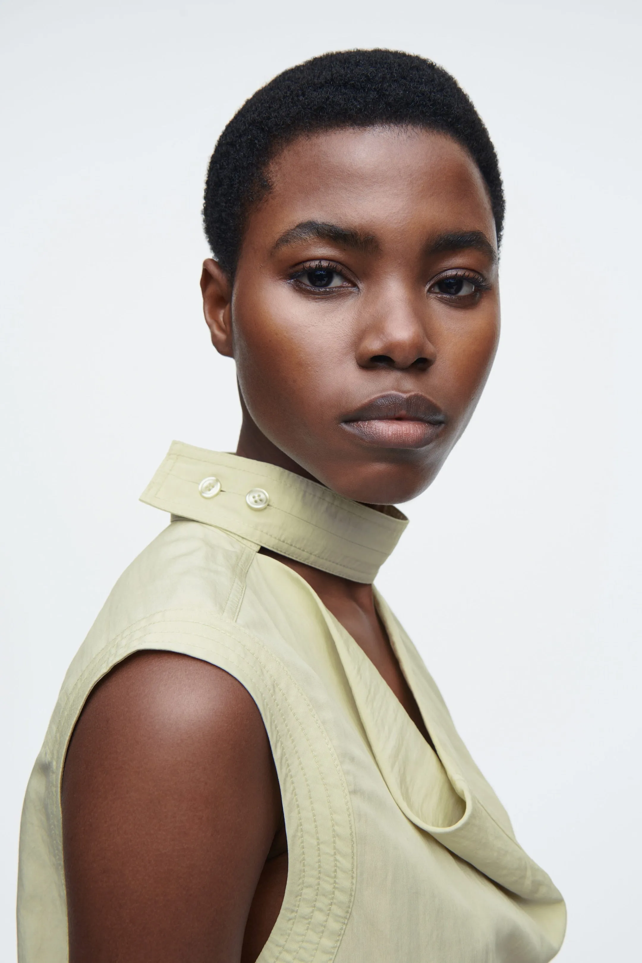 Sleeveless cut-out cowl-neck blouse