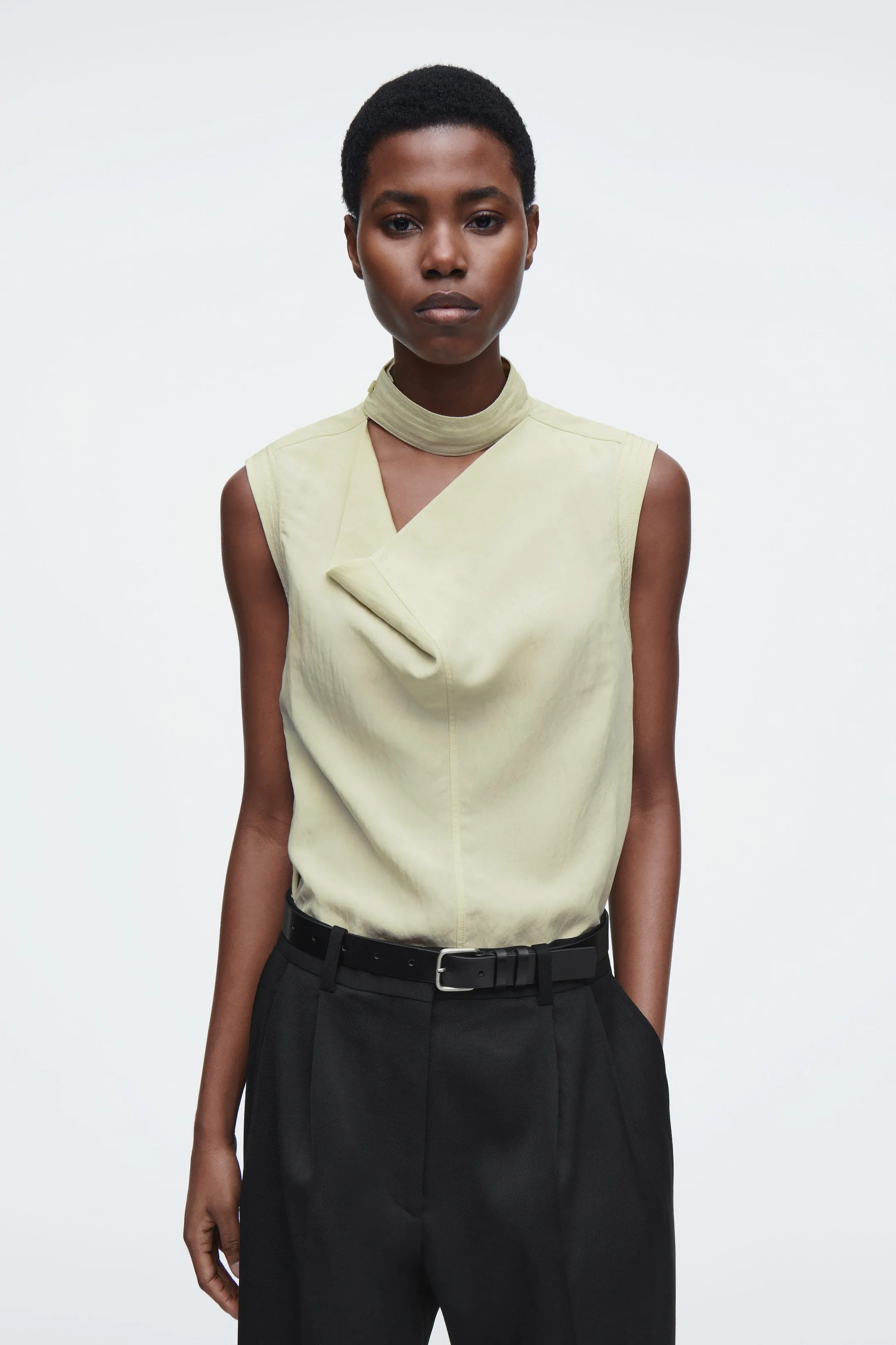 Sleeveless cut-out cowl-neck blouse